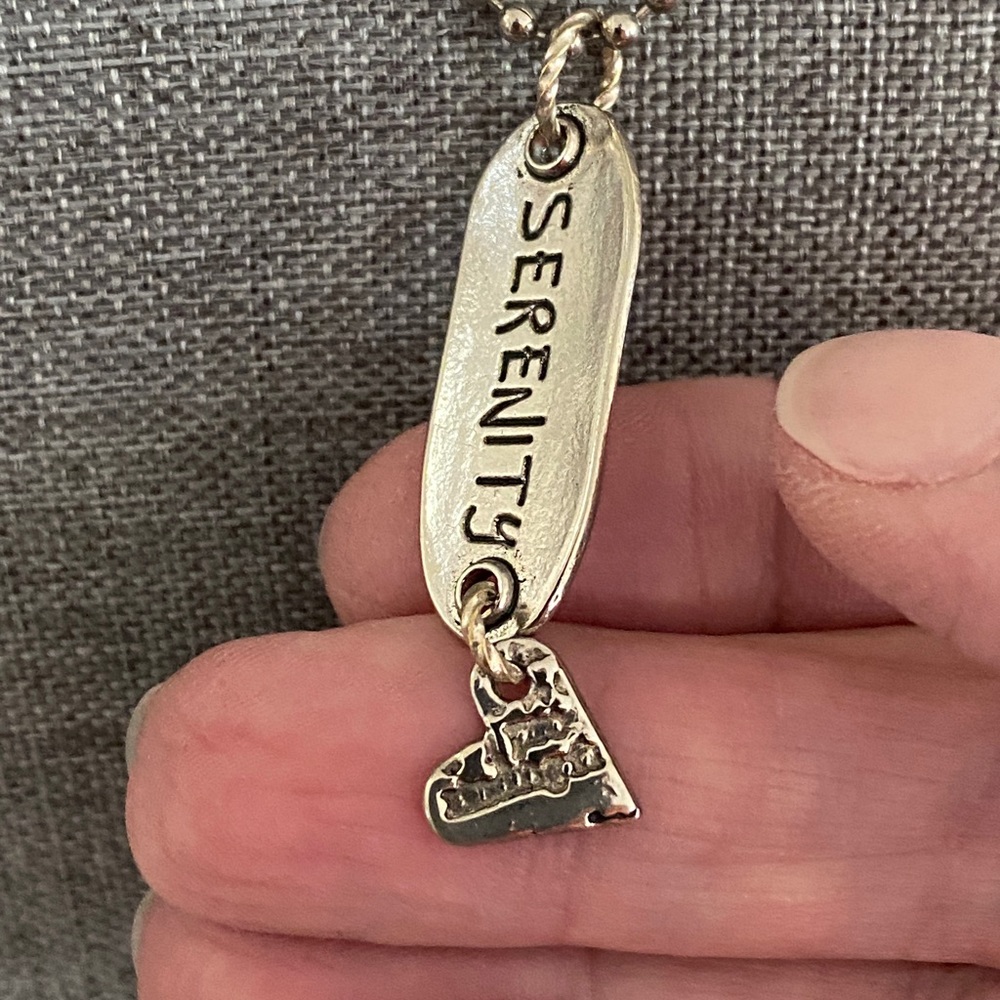 Serenity pendant with heart on beaded chain.
